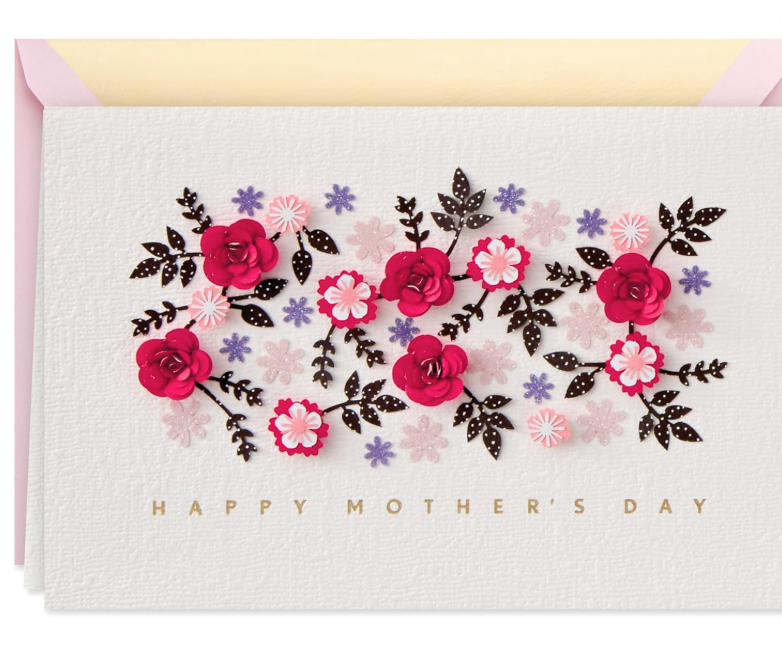 Hallmark Signature Mother's Day greeting card with 3D magenta roses, gold foil Happy Mother's Day text, and textured white cardstock, shown with a light pink envelope.