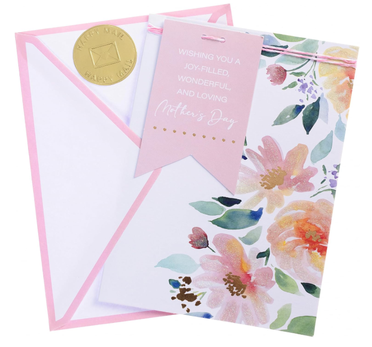 Handmade Mother's Day greeting card with watercolor floral design and a pink tag reading Wishing you a joy-filled, wonderful, and loving Mother's Day, shown with a matching envelope.